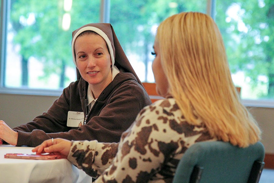 a nun speaks to a young adult